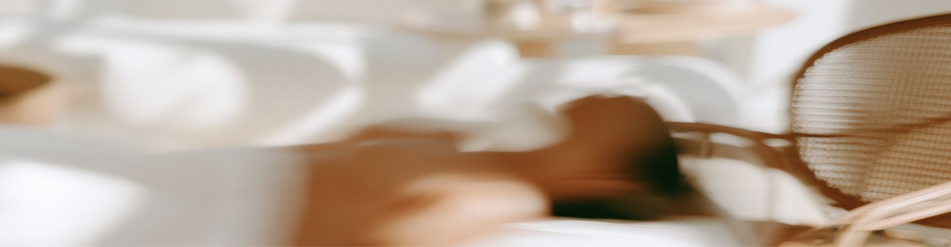 Ambiance feutrée d'un institut au positionnement premium, lumière naturelle et mobilier en rotin